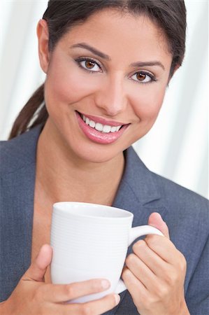 simsearch:400-04340722,k - Beautiful young Latina Hispanic woman or business woman smiling, relaxing and drinking a cup of tea or coffee Stock Photo - Budget Royalty-Free & Subscription, Code: 400-06203897