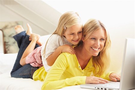 simsearch:400-04044108,k - Mother And Daughter Using Laptop Relaxing Sitting On Sofa At Home Stock Photo - Budget Royalty-Free & Subscription, Code: 400-06203961