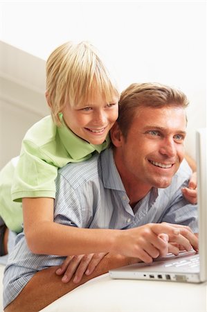 simsearch:400-04044108,k - Father And Son Using Laptop Relaxing Sitting On Sofa At Home Stock Photo - Budget Royalty-Free & Subscription, Code: 400-06203981