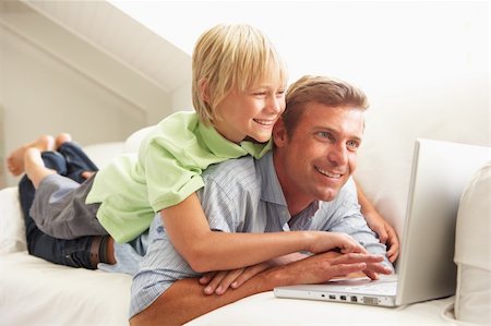 simsearch:400-04044108,k - Father And Son Using Laptop Relaxing Sitting On Sofa At Home Stock Photo - Budget Royalty-Free & Subscription, Code: 400-06203983