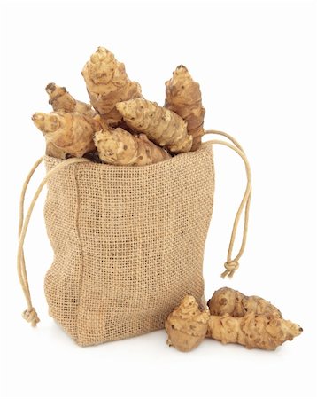Jerusalem artichoke raw vegetables in a hessian drawstring sack and loose over white background. Stock Photo - Budget Royalty-Free & Subscription, Code: 400-06327227