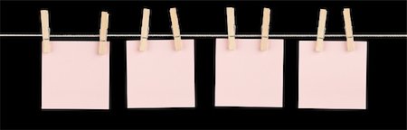 simsearch:400-05915058,k - Four blank pink sticky notes held on a string with clothespins isolated on black. Stock Photo - Budget Royalty-Free & Subscription, Code: 400-06328015