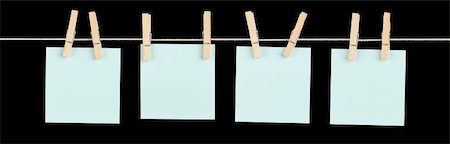 simsearch:400-06203504,k - Four blank blue sticky notes held on a string with clothespins isolated on black. Stock Photo - Budget Royalty-Free & Subscription, Code: 400-06328016