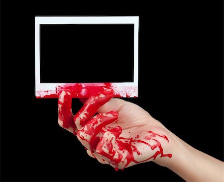 simsearch:400-04075629,k - A blood covered hand holding up a piece of blank instant film isolated on black. Stock Photo - Budget Royalty-Free & Subscription, Code: 400-06328031