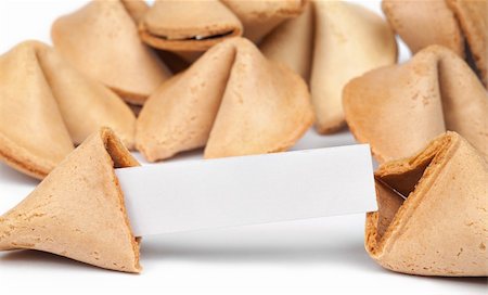 A fortune cookie with fortune paper in front of a pile of other cookies isolated on white. Foto de stock - Royalty-Free Super Valor e Assinatura, Número: 400-06328057