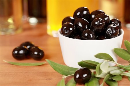 eating olive - Black olives in a bowl with olive oil in the background Stock Photo - Budget Royalty-Free & Subscription, Code: 400-06328428