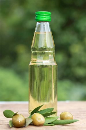 eating olive - Olive oil in a small bottle on a wooden table Stock Photo - Budget Royalty-Free & Subscription, Code: 400-06328447