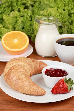 Breakfast with a croissant and strawberry jam. Served with milk, an orange and milk. Fotografie stock - Microstock e Abbonamento, Codice: 400-06328453