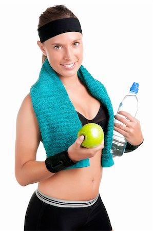 ruigsantos (artist) - Woman holding an apple and a bottle of water after a workout in the gym, isolated in a white background Fotografie stock - Microstock e Abbonamento, Codice: 400-06328678