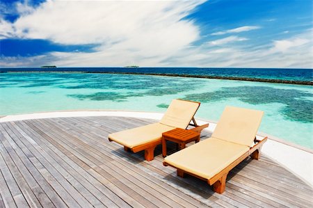 simsearch:400-04893796,k - Two deck chairs on the wooden footpath in the Maldives Foto de stock - Super Valor sin royalties y Suscripción, Código: 400-06328724