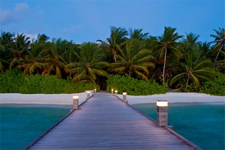 simsearch:400-05742448,k - Tropical Maldivian paradise - a jetty leading to a beautiful tropical toll hidden in the azure Indian ocean. Evening shot. Stock Photo - Budget Royalty-Free & Subscription, Code: 400-06328732