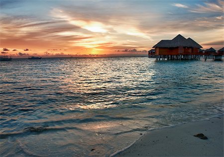 Beautiful vivid sunset over beach with the water villas in the Indian ocean, Maldives Stock Photo - Budget Royalty-Free & Subscription, Code: 400-06328733