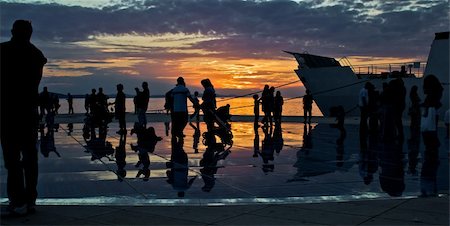 Greetings to the sun installation in Zadar, people silhouette at sunset Stock Photo - Budget Royalty-Free & Subscription, Code: 400-06328910