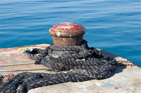 simsearch:400-05254289,k - Old rusty mooring bollard on pier by the sea Photographie de stock - Aubaine LD & Abonnement, Code: 400-06328948