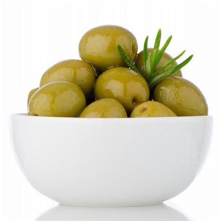 eating olive - Green olives in a white ceramic bowl on white background. Stock Photo - Budget Royalty-Free & Subscription, Code: 400-06329048