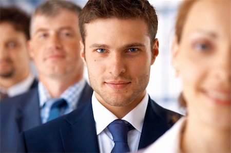 shyshka (artist) - Closeup portrait of a young businessman standing in the row with his colleagues. Photographie de stock - Aubaine LD & Abonnement, Code: 400-06329099