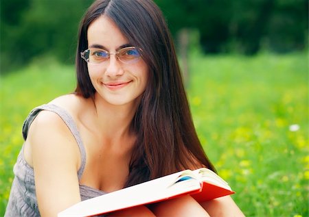 Young  female with a book  on a green meadow Stock Photo - Budget Royalty-Free & Subscription, Code: 400-06329092