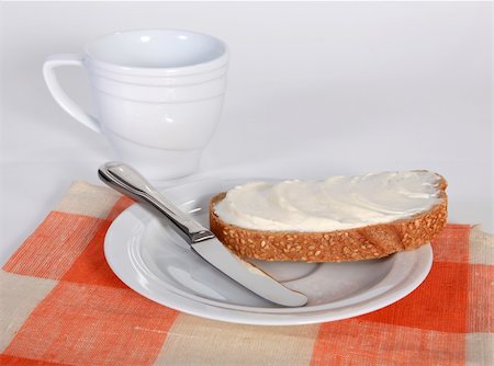 Appetizing sandwich with butter on the white saucer Fotografie stock - Microstock e Abbonamento, Codice: 400-06329167