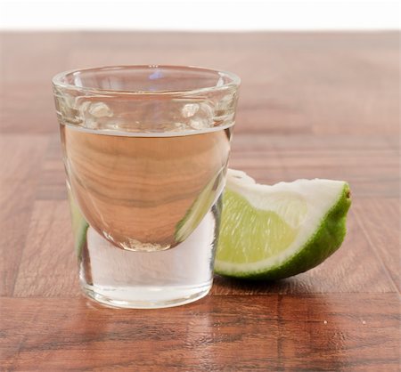 tequila shot on a bar top with a lime wedge Stock Photo - Budget Royalty-Free & Subscription, Code: 400-06334012