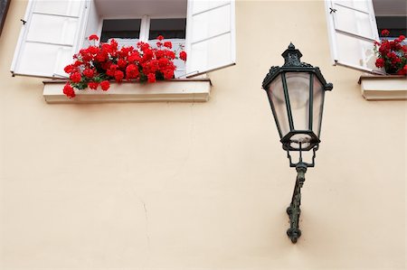 pictures of house street lighting - Vintage lantern near open windows with red flowers on the wall of dwelling house Stock Photo - Budget Royalty-Free & Subscription, Code: 400-06330007