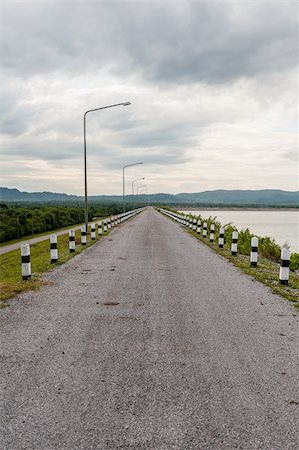 Road to mountain on dam with coud in sky Stock Photo - Budget Royalty-Free & Subscription, Code: 400-06330311