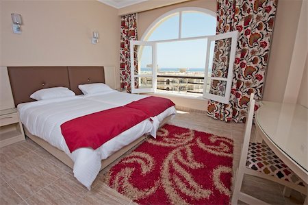 simsearch:700-00864697,k - Luxury hotel bedroom with a tropical sea view Stock Photo - Budget Royalty-Free & Subscription, Code: 400-06330357