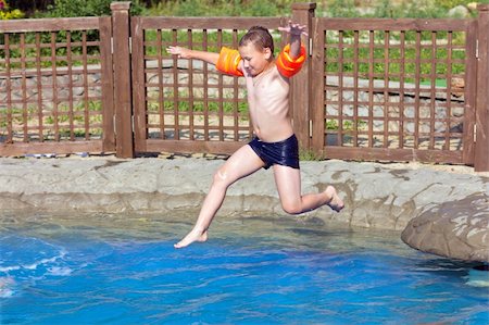 child jumps into the pool with water Stock Photo - Budget Royalty-Free & Subscription, Code: 400-06330385