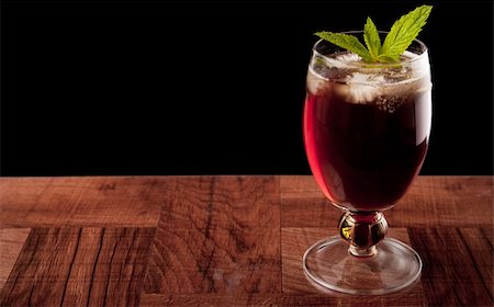 fresh glass of ice water - sweet iced tea on a bar top isolated on a black background garnished with fresh mint Stock Photo - Budget Royalty-Free & Subscription, Code: 400-06331344