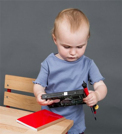 child with hard drive and tools in grey background Photographie de stock - Aubaine LD & Abonnement, Code: 400-06332404