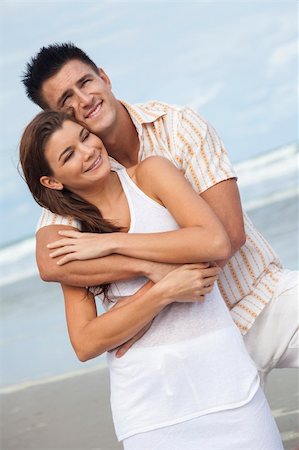 simsearch:400-06751687,k - A young man and woman having fun dancing as a romantic couple on a beach with a bright blue sky Stock Photo - Budget Royalty-Free & Subscription, Code: 400-06333465