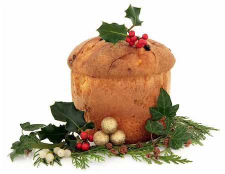 Panettone christmas cake with floral decoration of holly, ivy, mistletoe and cedar cypress leaf sprigs with pine cones and gold bauble cluster over white background. Stock Photo - Budget Royalty-Free & Subscription, Code: 400-06356031