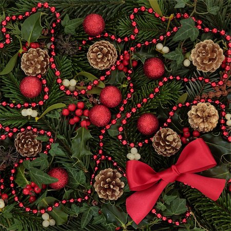 simsearch:400-06356099,k - Christmas background decoration of holly, mistletoe and ivy leaf springs with blue spruce, pine cones and red bow and bauble arrangement. Stock Photo - Budget Royalty-Free & Subscription, Code: 400-06356174