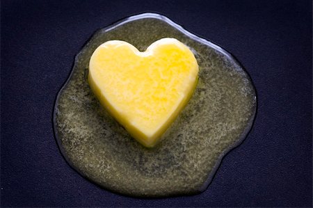 a heart shaped butter pat melting on a non-stick surface Stockbilder - Microstock & Abonnement, Bildnummer: 400-06357453