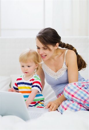 simsearch:400-04712944,k - Modern young mother and baby using laptop Stock Photo - Budget Royalty-Free & Subscription, Code: 400-06358502