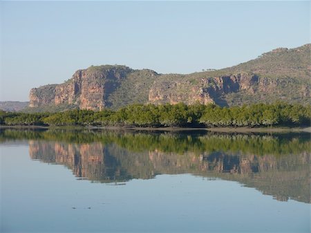 Serene early morning reflections of coastal cliffs at Porosus Creek on the Kimberley Coast of North Western Australia Stock Photo - Budget Royalty-Free & Subscription, Code: 400-06358812