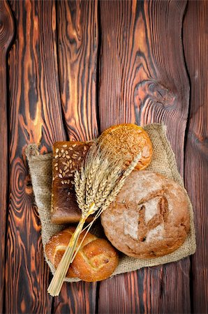 Bread and wheat on a wooden background Stock Photo - Budget Royalty-Free & Subscription, Code: 400-06359234