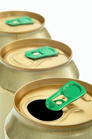 simsearch:400-06359503,k - three gold-colored cans in a row Photographie de stock - Aubaine LD & Abonnement, Code: 400-06359502