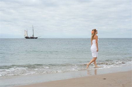 evening dress on beach - Girl in white dress on the coast with old ship in the background Stock Photo - Budget Royalty-Free & Subscription, Code: 400-06359511