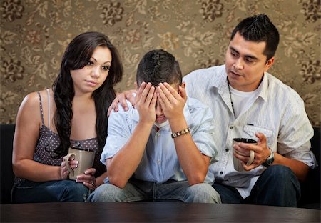 simsearch:400-06366240,k - Sympathetic Latino parents with depressed male teenager Stockbilder - Microstock & Abonnement, Bildnummer: 400-06366239