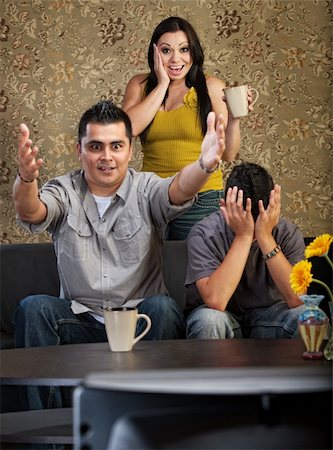 simsearch:400-06366240,k - Excited man and woman with distraught son watching television Stockbilder - Microstock & Abonnement, Bildnummer: 400-06366231