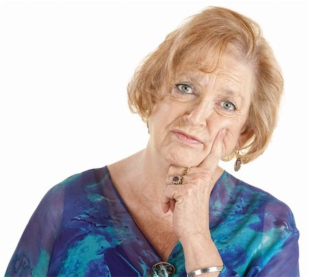 Serious Caucasian lady in blue with finger on cheek Stock Photo - Budget Royalty-Free & Subscription, Code: 400-06366248