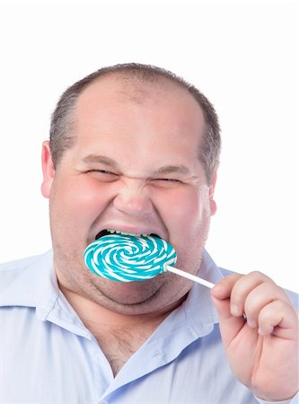 simsearch:400-07305387,k - Fat Man in a Blue Shirt, Eating a Lollipop, isolated Photographie de stock - Aubaine LD & Abonnement, Code: 400-06366529