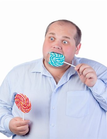 simsearch:400-07305387,k - Fat Man in a Blue Shirt, Eating a Lollipop, isolated Photographie de stock - Aubaine LD & Abonnement, Code: 400-06366530