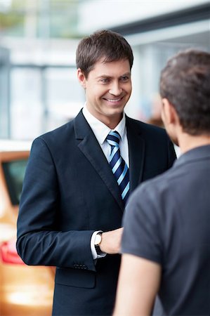 Young man with a salesman in a motor show Stock Photo - Budget Royalty-Free & Subscription, Code: 400-06366592