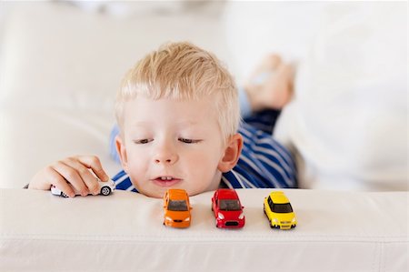 simsearch:400-06737087,k - young caucasian boy plays with colorful toy cars Fotografie stock - Microstock e Abbonamento, Codice: 400-06366932