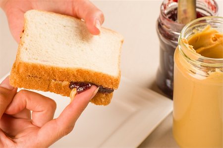 preparing and sandwich - Dripping raspberry jam and peanut butter sandwich Stock Photo - Budget Royalty-Free & Subscription, Code: 400-06360548