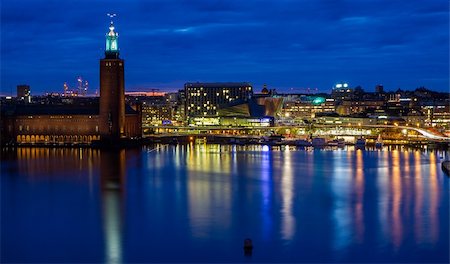 stockholm city hall - Colourful version of skyline overlooking Stockholm city hall. Reflections of neon lights in the water. Stock Photo - Budget Royalty-Free & Subscription, Code: 400-06360632