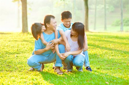 Happy Asian family having conversation at outdoor park Stock Photo - Budget Royalty-Free & Subscription, Code: 400-06363759