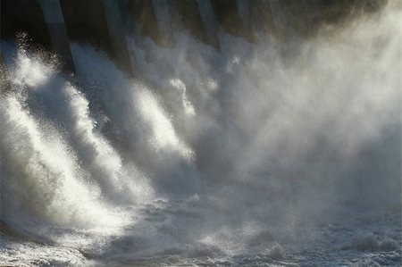 The sun dramatically backlighting the spillway and spray of a large hydroelectric dam overflow. Stock Photo - Budget Royalty-Free & Subscription, Code: 400-06384029