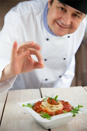 Male chef in restaurant kitchen is garnishing and preparing pasta dish Stock Photo - Budget Royalty-Free & Subscription, Code: 400-06384067